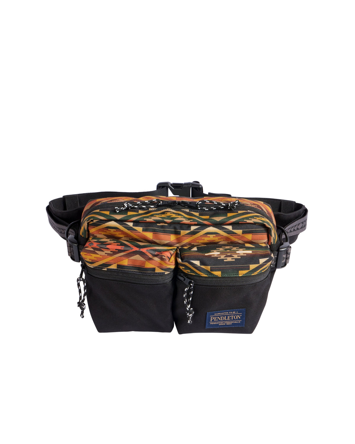 The Tumalo Olive Sling Crossbody by Pendleton features a striking black and brown geometric pattern, two zippered front pockets, and an adjustable strap. The Pendleton brand label is displayed on one pocket, giving this stylish waist bag a distinctive touch.