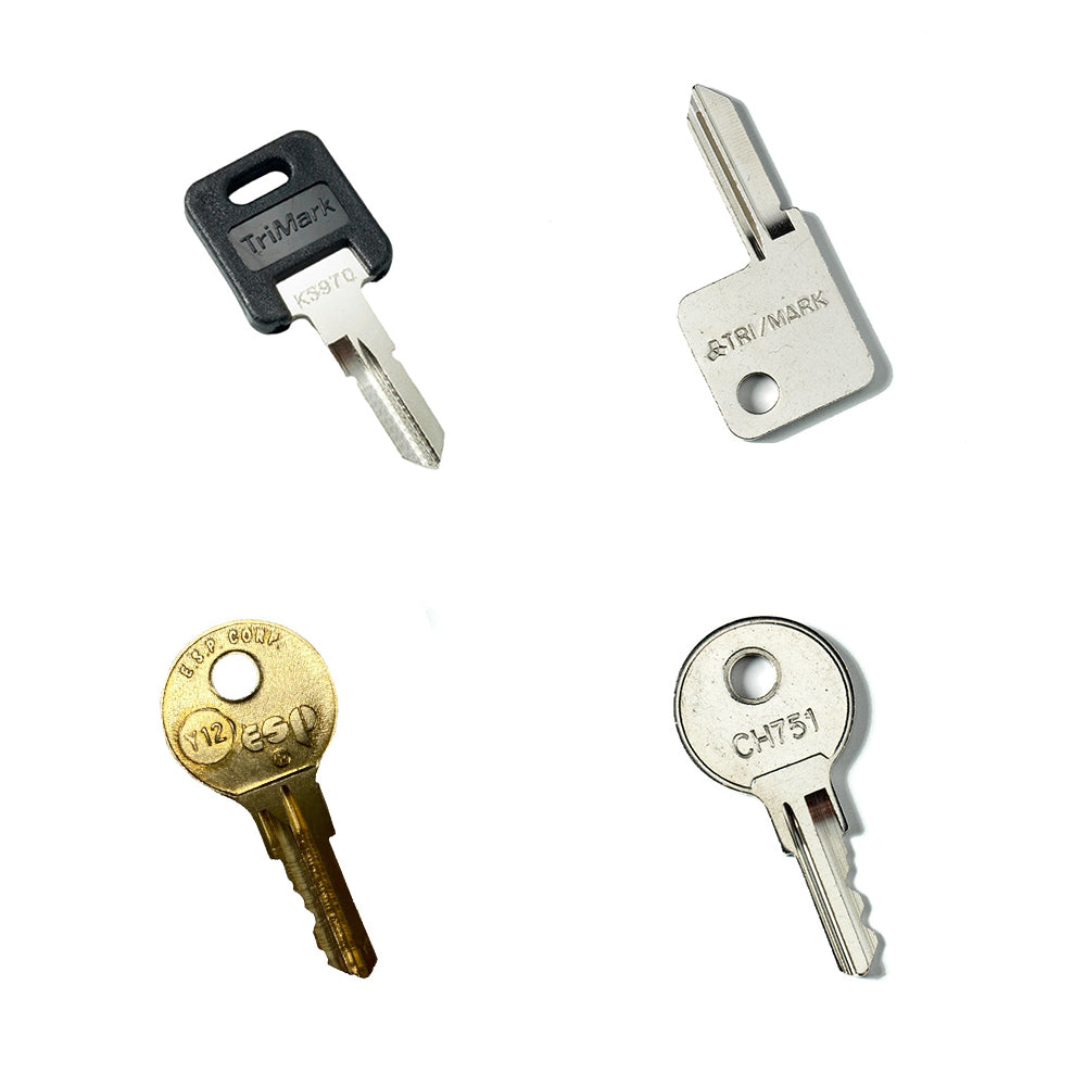 The Airstream Cut Key Bundle for Quiksilver Travel Trailers features four different keys on a white background, each with unique shapes and markings, including black, silver, and gold-colored heads—perfect as convenient pre-cut or spare trailer keys.