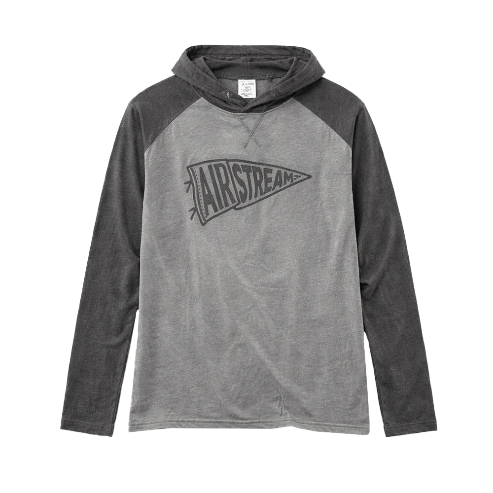 The Airstream Rally Pennant Colorblock Long Sleeve Hooded T-Shirt is a cozy gray hoodie with darker gray sleeves, featuring a bold AIRSTREAM pennant graphic on the front. Shown laid flat on a white background, this hooded t-shirt is perfect for travel or everyday wear.