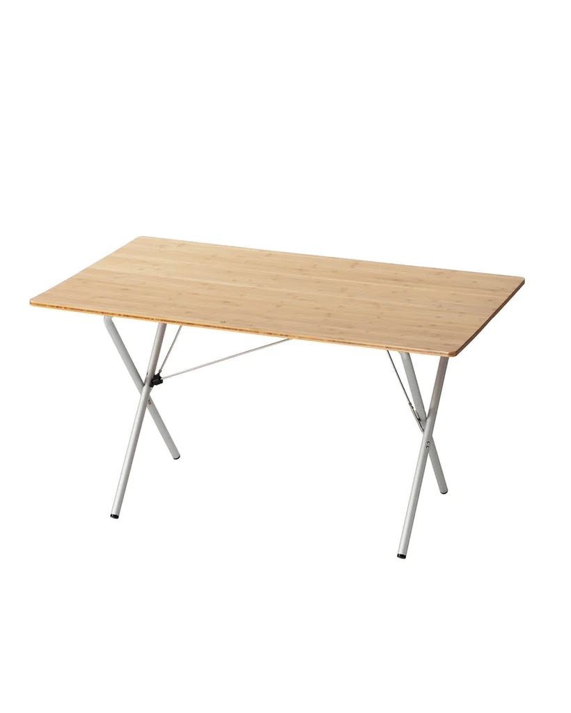 A Snow Peak Large Renewed Single Action Table with a laminated bamboo worktop and crossed aluminum legs, displayed against a white background.