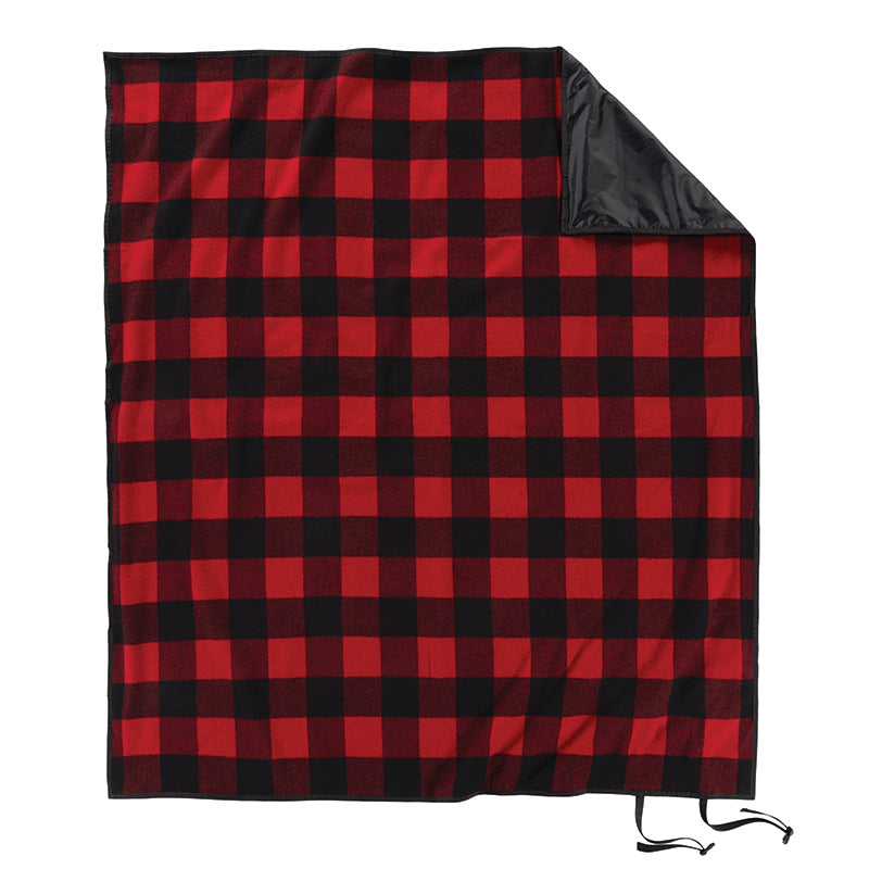 Introducing the Roll-Up Nylon Backed Blanket by Pendleton—a rectangular outdoor blanket adorned with a timeless red and black buffalo plaid design. A folded corner reveals its solid black nylon backing, highlighting its blend of style and durability. Equipped with two convenient black straps at one corner, this portable wool blanket ensures easy carrying on all your adventures.