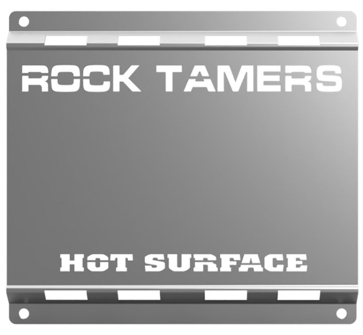 The Rock Tamers Stainless Steel Heat Shield is a metal plate designed to protect your mudflaps, featuring bold white stencil text with “ROCK TAMERS” at the top and “HOT SURFACE” at the bottom, serving as both a durable heat shield and an added mudflap guard.