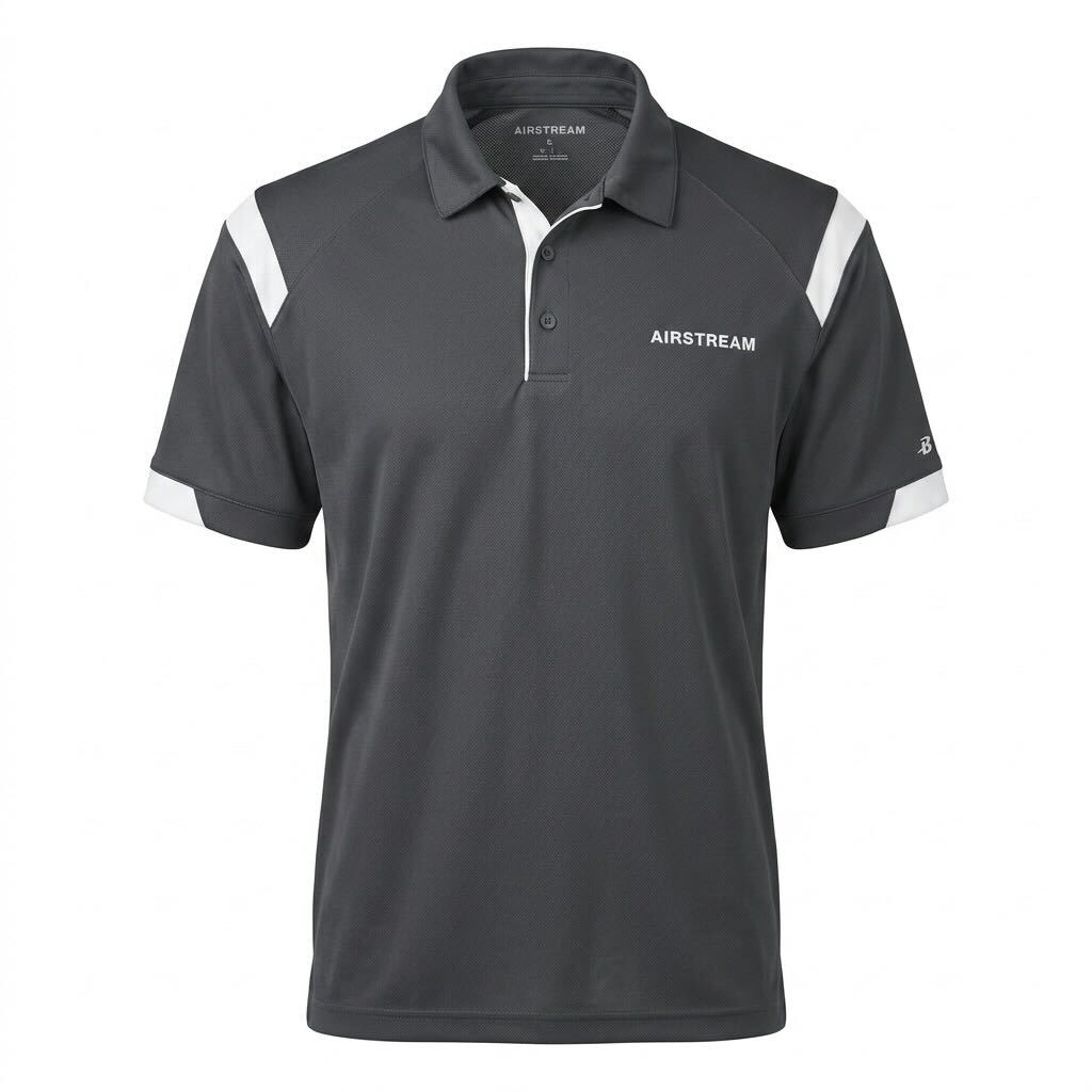 Introducing the Airstream Shoulder Stripe Polo in dark gray, featuring white accents on the shoulders and sleeves. This heritage-inspired polo offers a classic collar with three buttons, is crafted from sporty, breathable fabric for all-day comfort, and showcases “AIRSTREAM” printed on the left chest—bringing timeless Americana style to your wardrobe.
