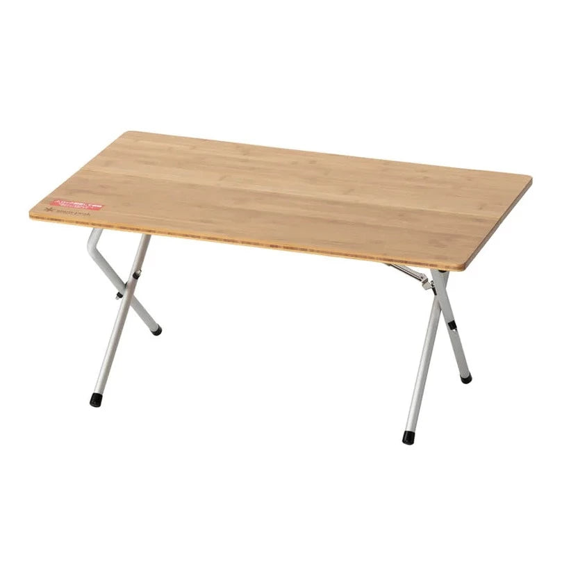 The Snow Peak Renewed Single Action Low Table is a rectangular portable camping table with a light wood finish and foldable metal legs, shown against a white background.