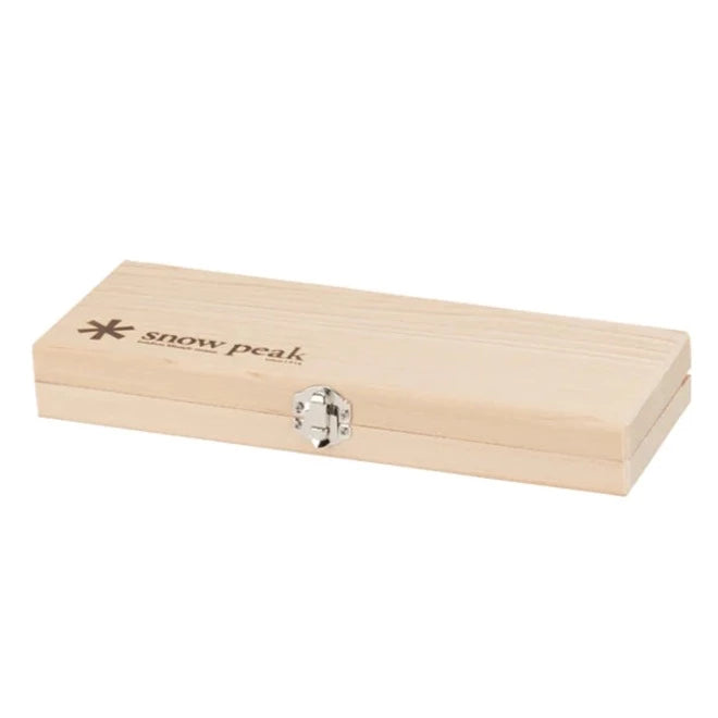 The Snow Peak Medium Chopping Board Set is an elegant rectangular birch wood box with a silver metal clasp, featuring the Snow Peak logo and name engraved in the top left corner. Designed for outdoor cooking, this cutting board set is photographed closed against a white background.