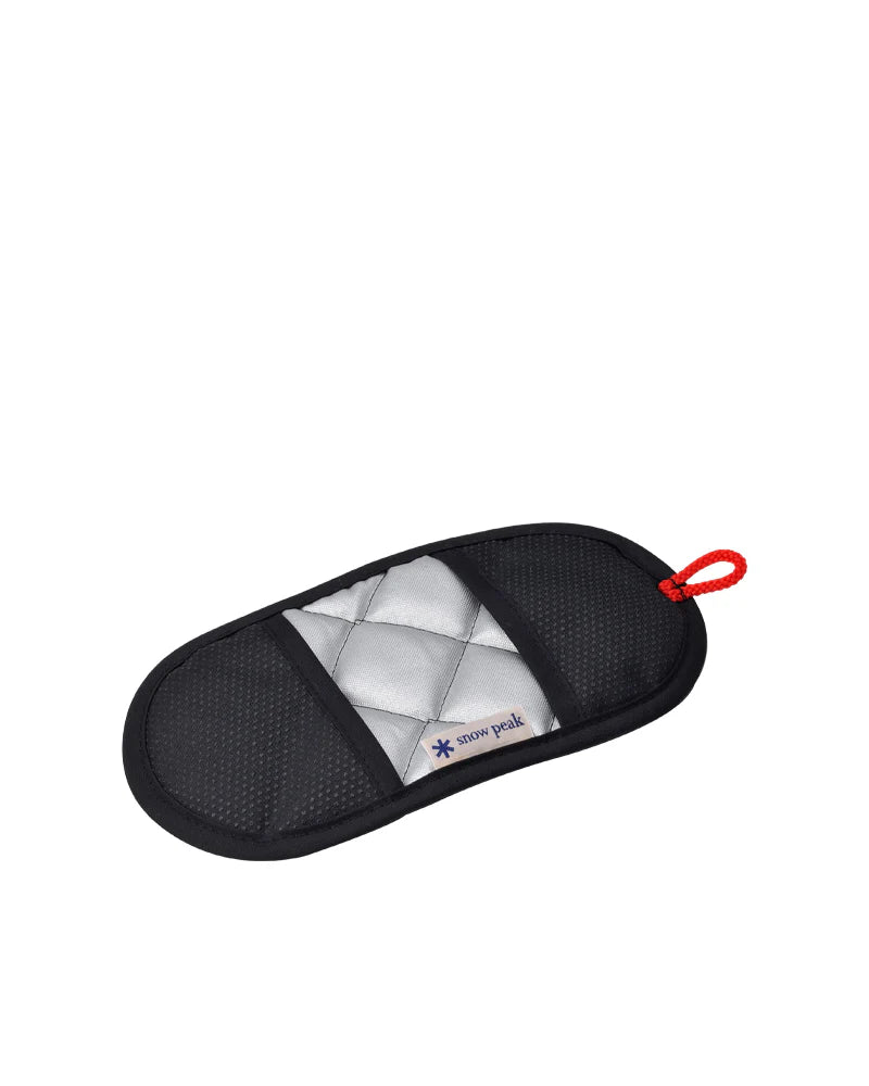 A rectangular, quilted silver and black pot holder with a red loop and the Snow Peak logo in the center—an essential accessory that perfectly complements your Snow Peak Field Cooker Pro. 3 Set or any premium camp kitchen cookware.