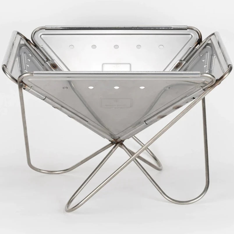 A foldable, stainless steel fire pit featuring a square-shaped basin and a minimalist, X-shaped metal stand against a plain white background—the perfect Snow Peak Pack & Carry Large Fireplace for those seeking both style and portability.
