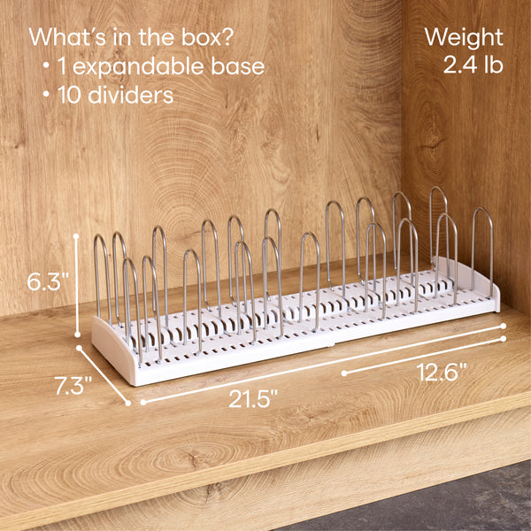 An Airstream StoreMore Roof Locker Dish Rack by YouCopia, in white, sits on a wooden shelf with 10 upright metal dividers. Measuring 6.3 x 7.3 x 12.6–21.5 inches and weighing 2.4 lb, this expandable and adjustable dishware organizer fits perfectly in tight spaces or Airstream roofs; the label details everything included in the box.
