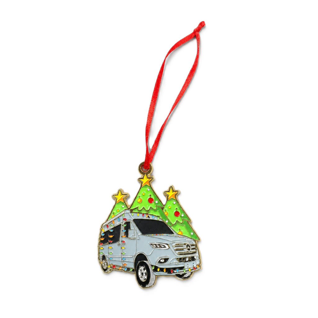 Add a touch of whimsy to your holiday décor with the Airstream Festive Touring Coach Holiday Ornament. Shaped like a festive van and topped with two Christmas trees and sparkling stars, this charming Christmas tree decoration is adorned with twinkling lights and hangs elegantly from a bright red ribbon—making it the perfect keepsake for your tree this season.