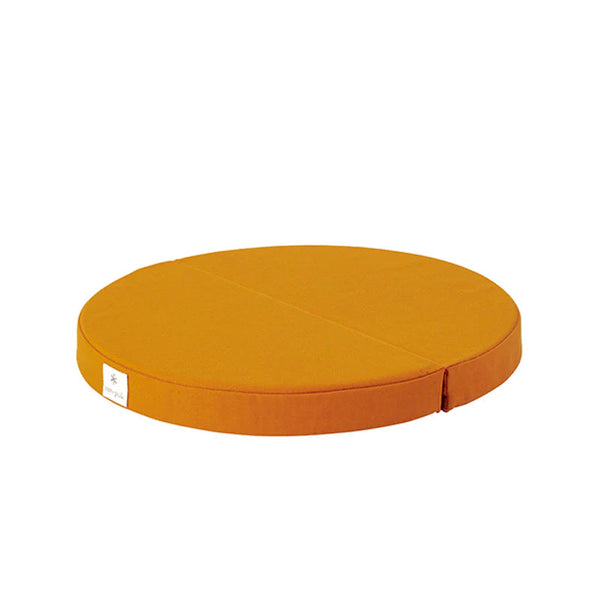 A round, low-profile cushion in a warm mustard yellow or orange-yellow fabric, shown from a three-quarters perspective on a solid white background.