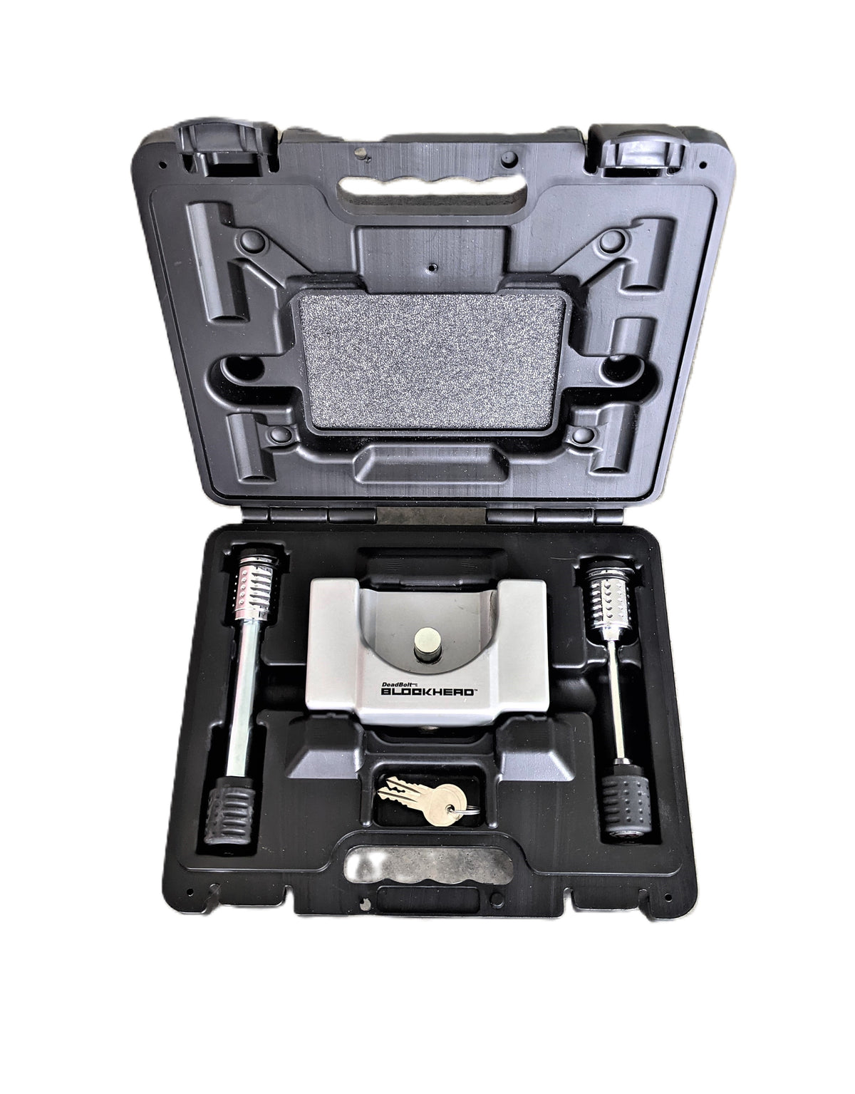 A black plastic case with a lock, two keys, two security bolts, and a metal device labeled BLOCKHEAD—all components of the Airstream Anti-Theft Hitch and Trailer Lock Kit—are neatly organized in fitted compartments to provide robust security for your Airstream.