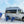Interstate on beach with sand two people walking towards water