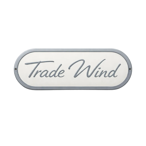 Decorative sign with 'Trade Wind' text on a white background