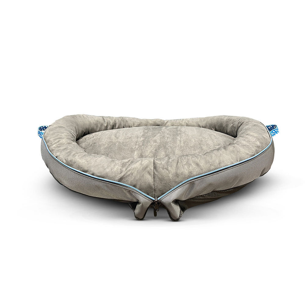 The Airstream Travel Pet Bed is a soft, gray, heart-shaped pet bed featuring plush padding and a slightly raised edge. Shown from the front on a white background, this charming portable pet bed makes an ideal accessory for on-the-go comfort.