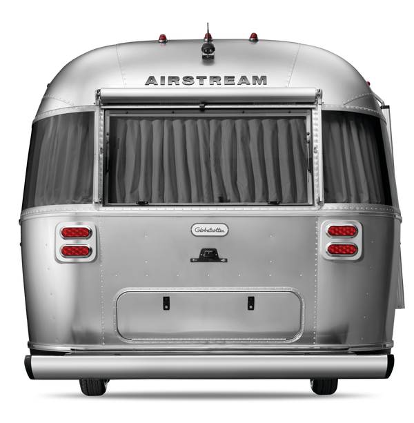 Silver Airstream trailer with curtains on a white background