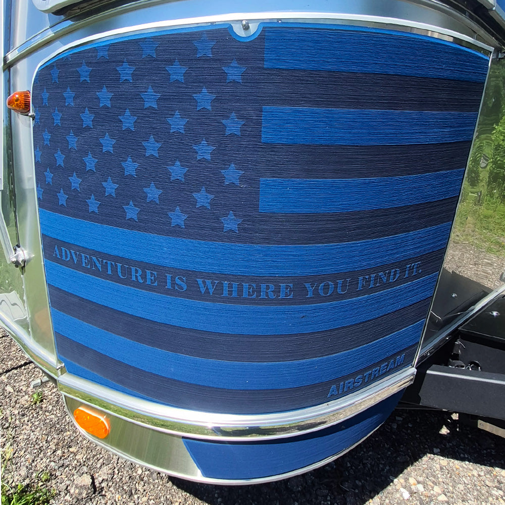 Blue American flag design on a vehicle with 'Adventure is Where You Find It' text, featuring the Airstream brand.