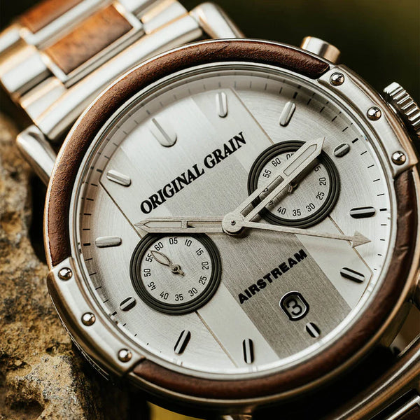 Close-up of a watch with 'Original Grain' and 'Airstream' branding on a textured surface.