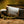 Close-up of a metallic belt buckle with 'Airstream' branding on a blurred natural background
