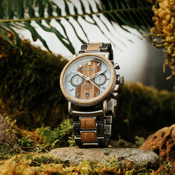 Wooden watch with metal band on a natural background
