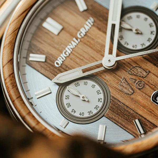 Wooden watch with 'Original Grain' branding on a wooden background