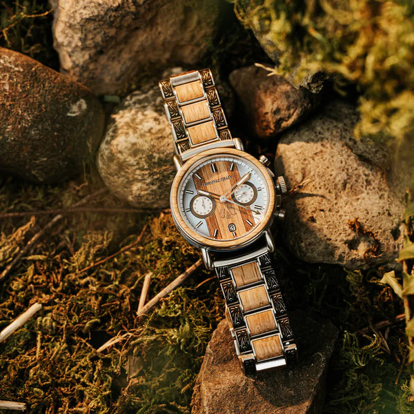 Wooden watch on a stone surface with a natural background