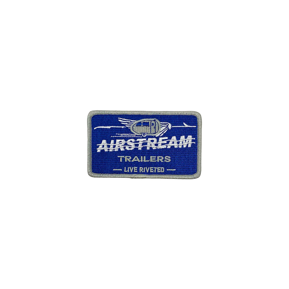 The Airstream Live Riveted Vintage Patch features a blue and silver embroidered design with “AIRSTREAM TRAILERS LIVE RIVETED” text and a winged trailer graphic above, capturing the retro spirit perfect for fans of classic Airstream adventures.