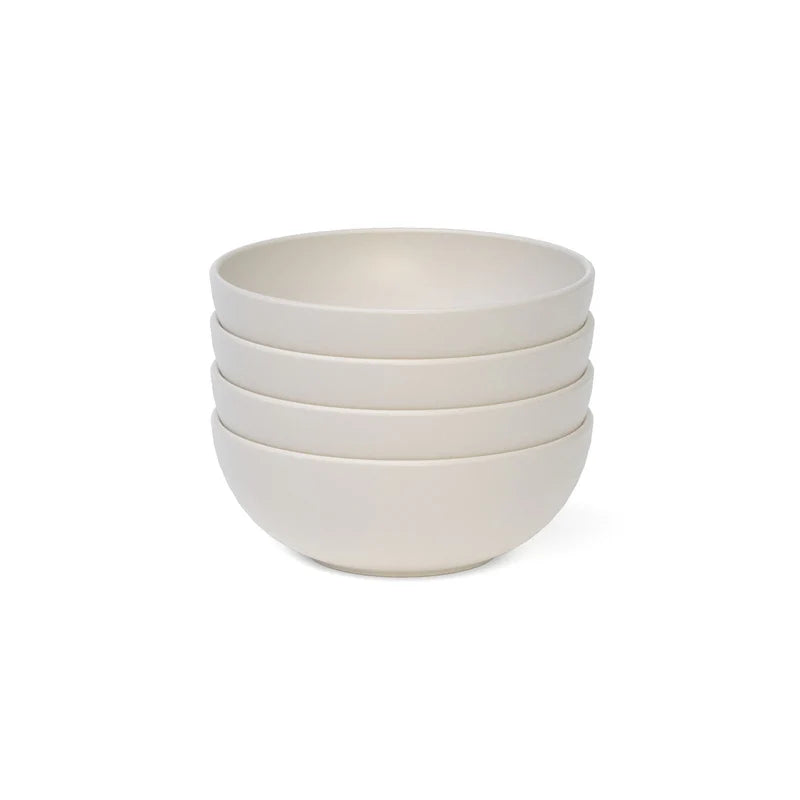 Four round cereal bowls from Ekobo—crafted from durable, BPA-free bamboo fiber—are stacked neatly atop one another against a white background.