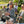 People at an outdoor event with a bar setup and people in the background.