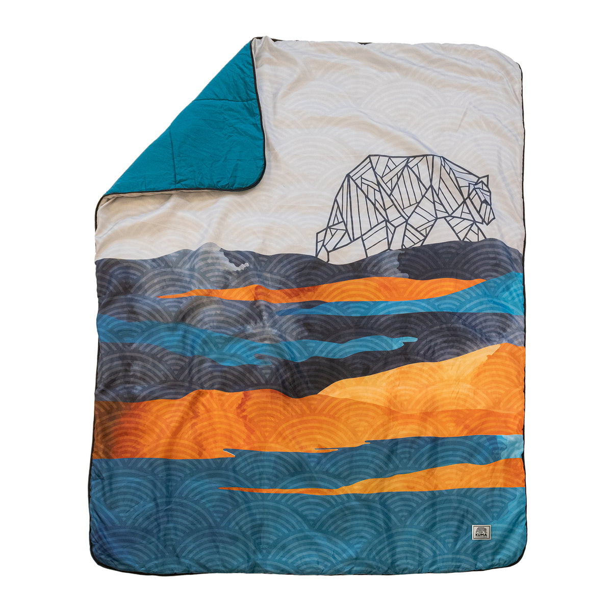 The Kamp Blanket by KUMA Outdoor Gear is a vibrant and durable polyester blanket adorned with abstract wave patterns in blue, orange, and gray shades, highlighted by a geometric bear outline on the upper right. Its flipped corner reveals a solid teal underside, making it an ideal choice for stylish camping trips or any outdoor adventure.