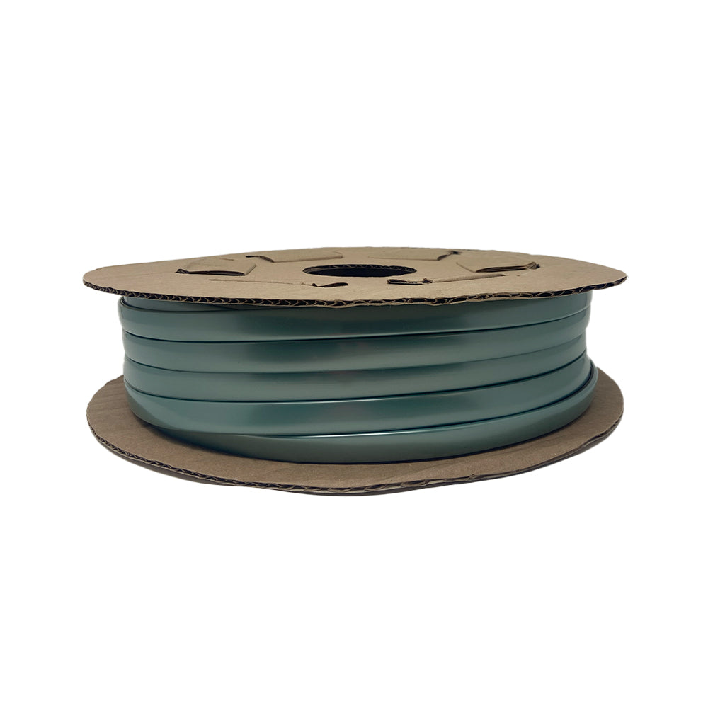 A spool of Airstream Premium Replacement Belt Trim for Travel Trailers, coiled between two round pieces of cardboard, is shown from the side against a white background; this green plastic strapping serves as an exterior accessory or can be used to replace aluminum trim on Airstreams.