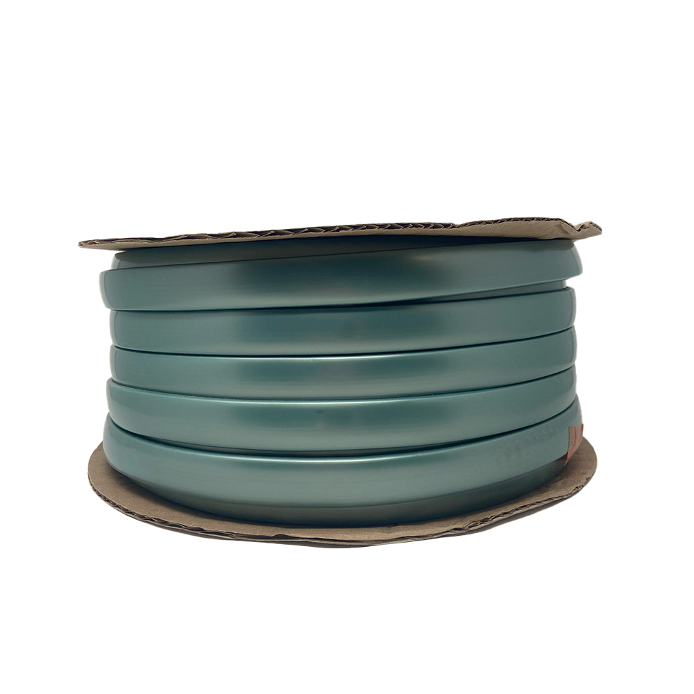 A spool of teal-colored rub rail, neatly coiled and secured between two round cardboard discs, is displayed against a white background—ideal as the Airstream Premium Replacement Rub Rail for Travel Trailers to enhance your classic riveted aluminum Airstream.