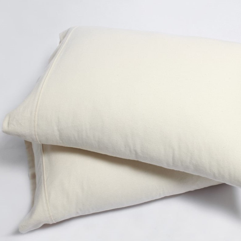 Two pillows stacked atop one another against a white background, each featuring an Organic Cotton Flannel Pillowcase in a subtle cream hue.