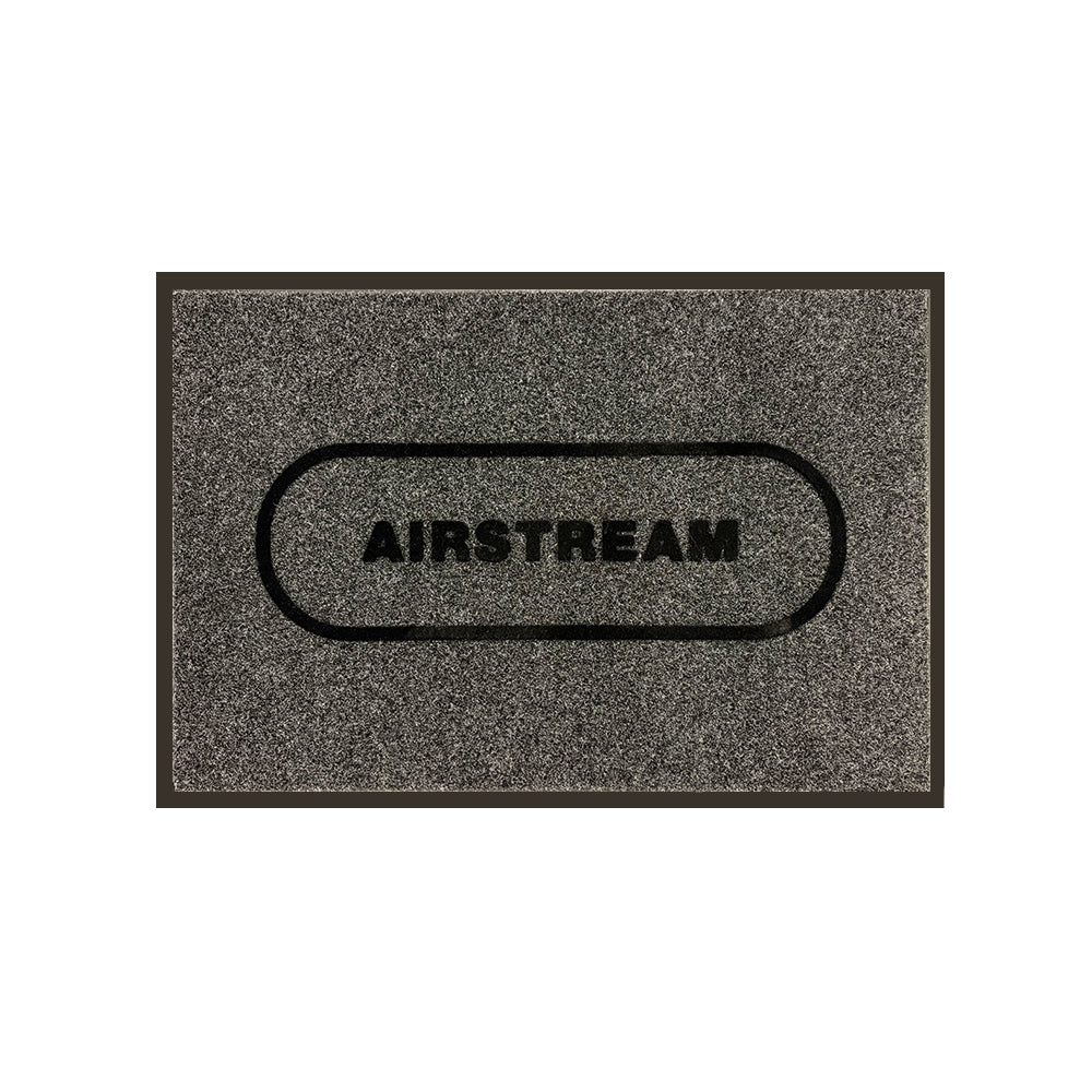 Airstream Decorative Outdoor Entrance Mat—gray, rectangular entry mat featuring the word “AIRSTREAM” in bold black letters centered inside a black-outlined oval, ideal as a stylish Airstream mat for your travel trailer.