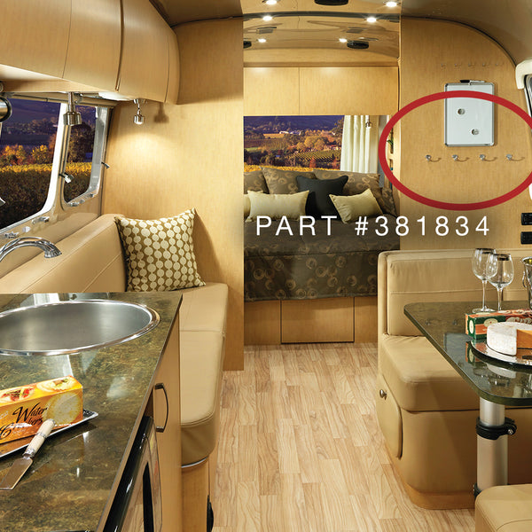 Interior of a luxury Airstream with a kitchen area, seating, and decorative elements.