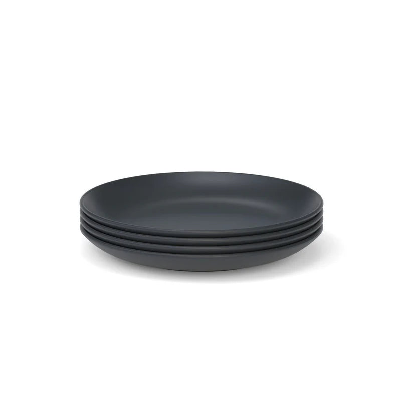A set of four Bamboo Round Plates by Ekobo, crafted from eco-friendly bamboo composite with a matte black finish, is displayed against a plain white background.