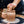 Person working on a clay pot on a pottery wheel