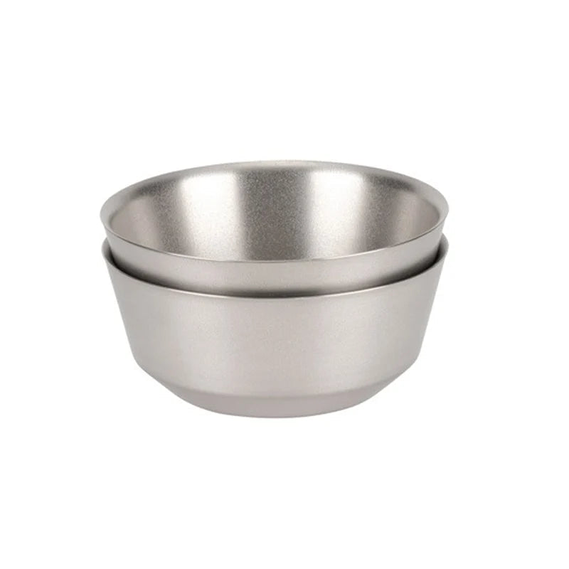 Two stainless steel bowls stacked on a white background