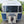 Airstream travel trailer with blue and white exterior in a natural setting