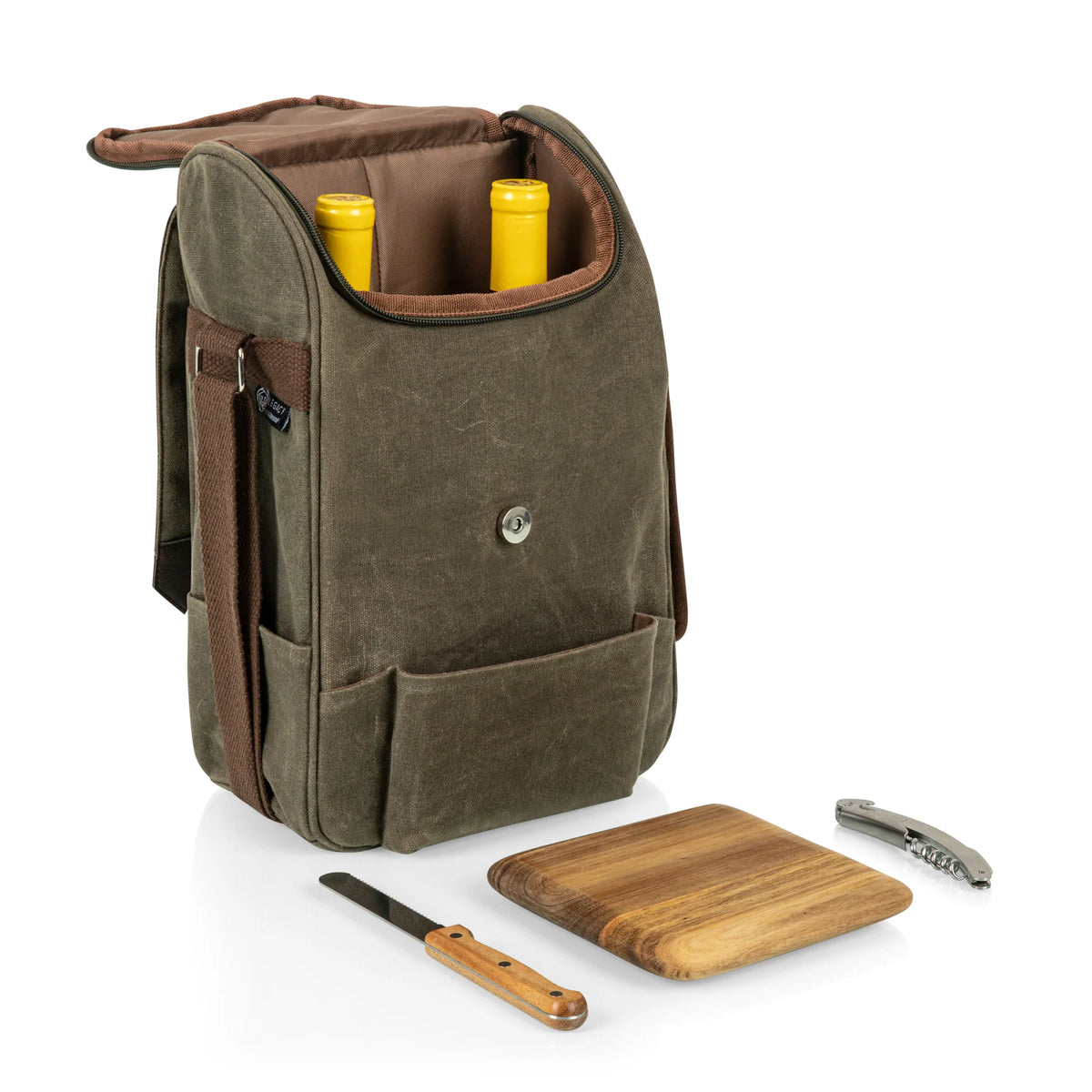 The Airstream Wine Bottle & Cheese Bag, a brown picnic carrier, holds two wine bottles. In front, a small wooden cutting board, a wood-handled cheese knife, and a metal corkscrew are all arranged neatly on a white surface.