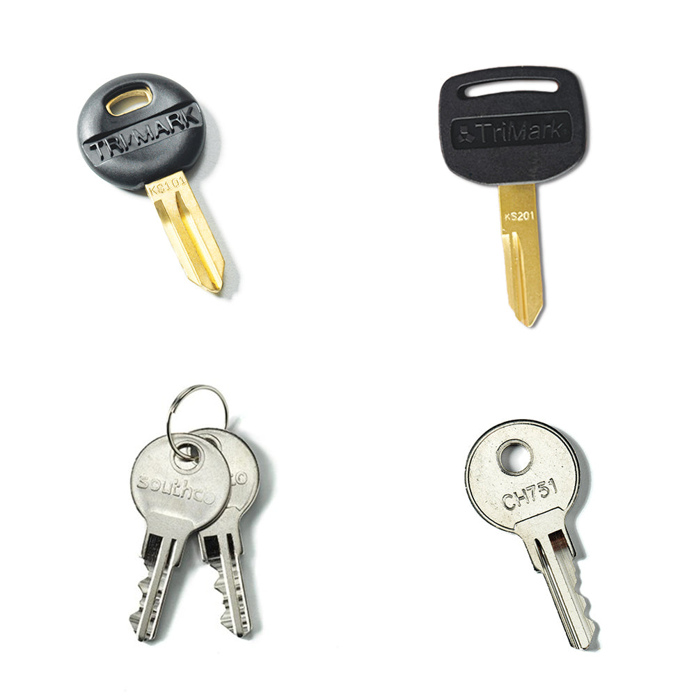 The Airstream Cut Key Bundle for World Traveler Travel Trailers displays four different keys: two single gold TriMark keys with black plastic heads, a pair of silver Southco keys on a ring, and one silver CH751 key with a circular head. These pre-cut trailer keys are perfect as spare RV keys and include popular options like the Airstream World Traveler keys for added convenience.