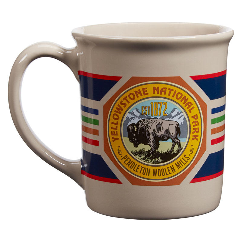 The National Parks Mug by Pendleton is a beige coffee mug showcasing a Yellowstone National Park emblem with a bison, “Est 1872,” and vibrant stripes. Inspired by the classic patterns of National Park blankets, this Pendleton design also includes the words “Pendleton Woolen Mills.” It’s an ideal addition to any National Park mug collection.